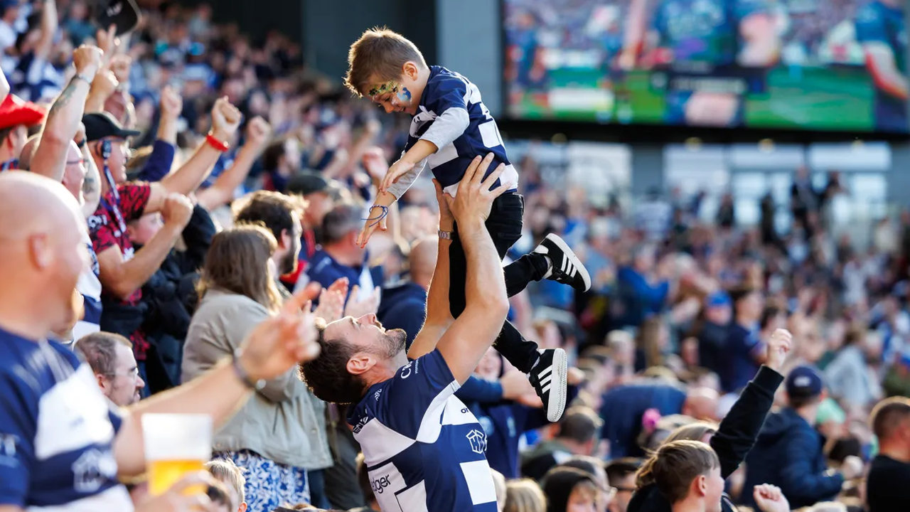 Bristol Bears crowd - father lifts child up in celebration